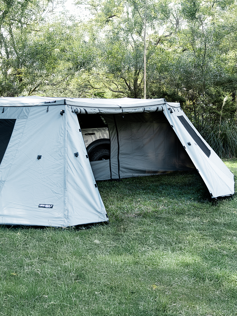 Close up view of the Lucas Creek 180 Fantail free standing awning with the outer and inner wall kit installed and one door fully open to see inside