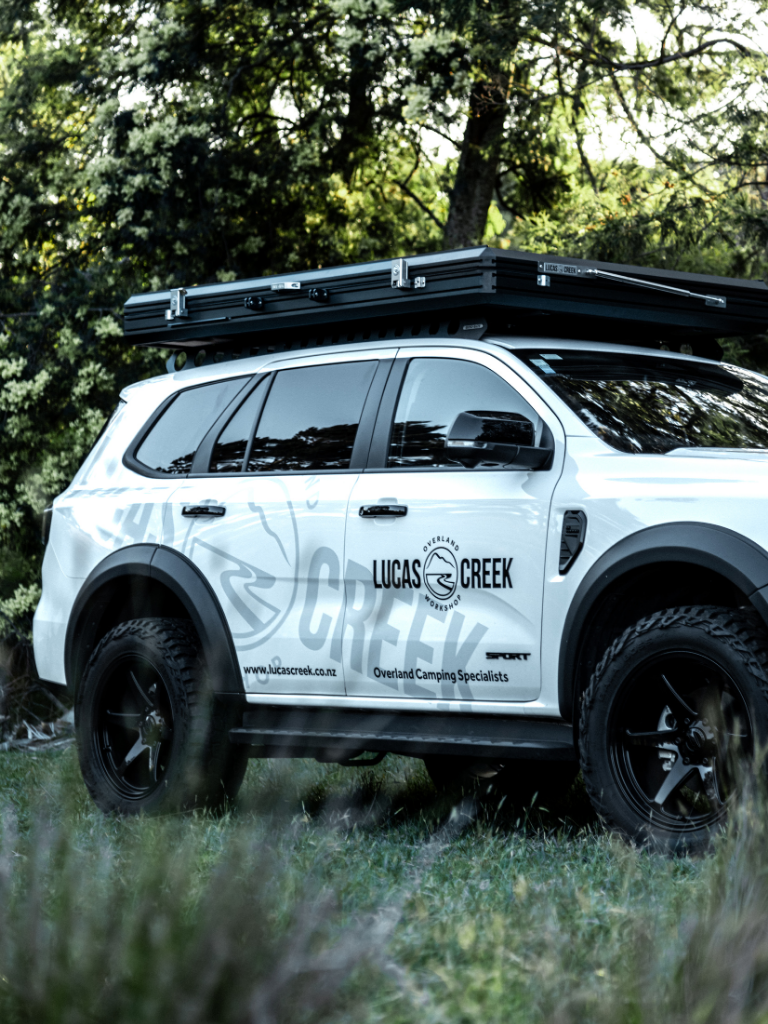 Close up of the Lucas Creek D-Luxe aluminium hard shell roof top tent closed on the top of the Lucas Creek Ford Everest