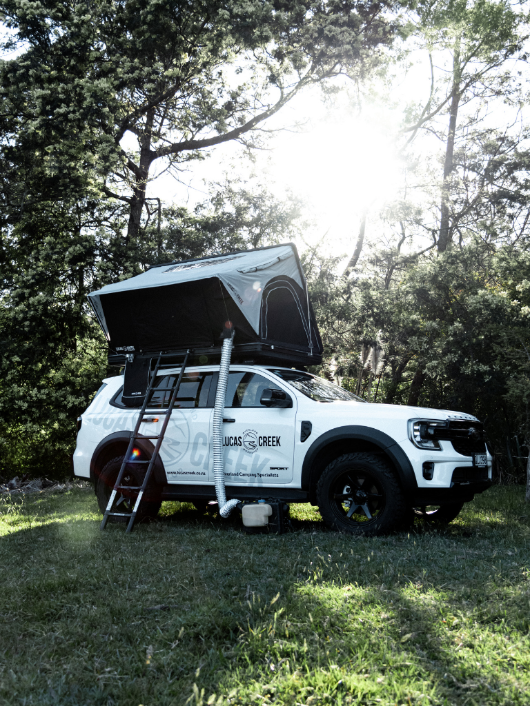 Lucas Creek D-Luxe aluminium hard shell tent showing the diesel heater duct being used