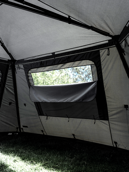 Internal view of the Lucas Creek 180 Fantail free standing awning full wall kit with the window partly down to show the mesh window behind 
