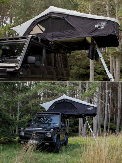 Lucas Creek soft shell rooftop tent open on a vehicle with windows rolled up in an outdoor forrest camping environment 